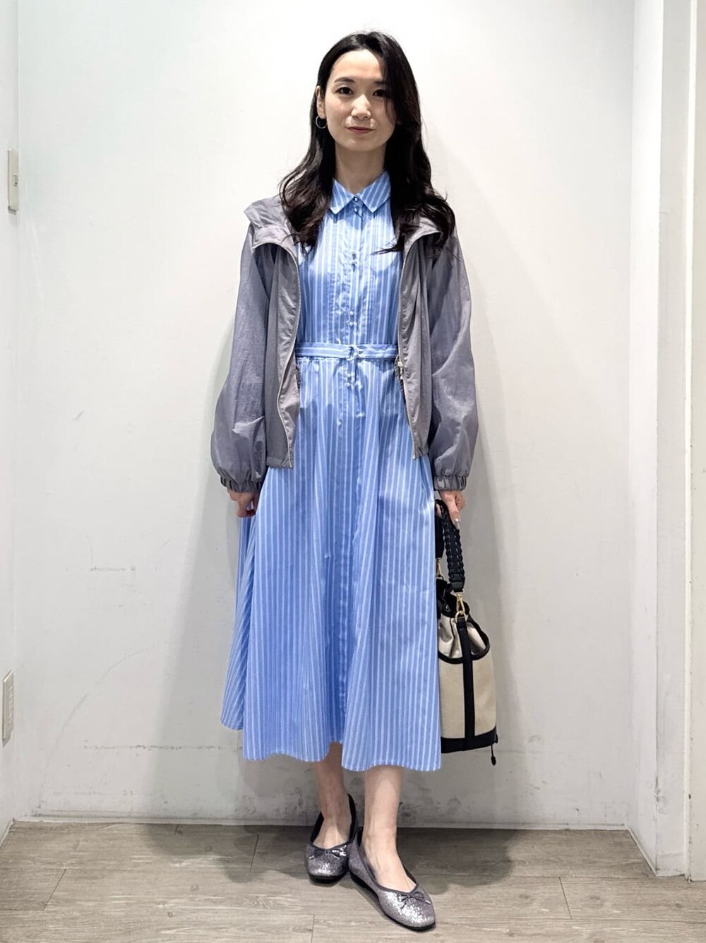 シルバー系のパンプス、ブルー系のワンピース、グレー系のブルゾンを着用したレディースの春コーディネートの3枚目の写真