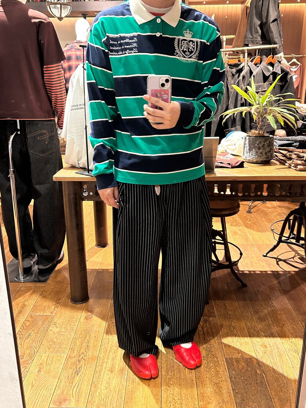 グリーン系のTシャツ/カットソー、ブラック系のスラックスを着用したメンズの夏コーディネートの2枚目の写真