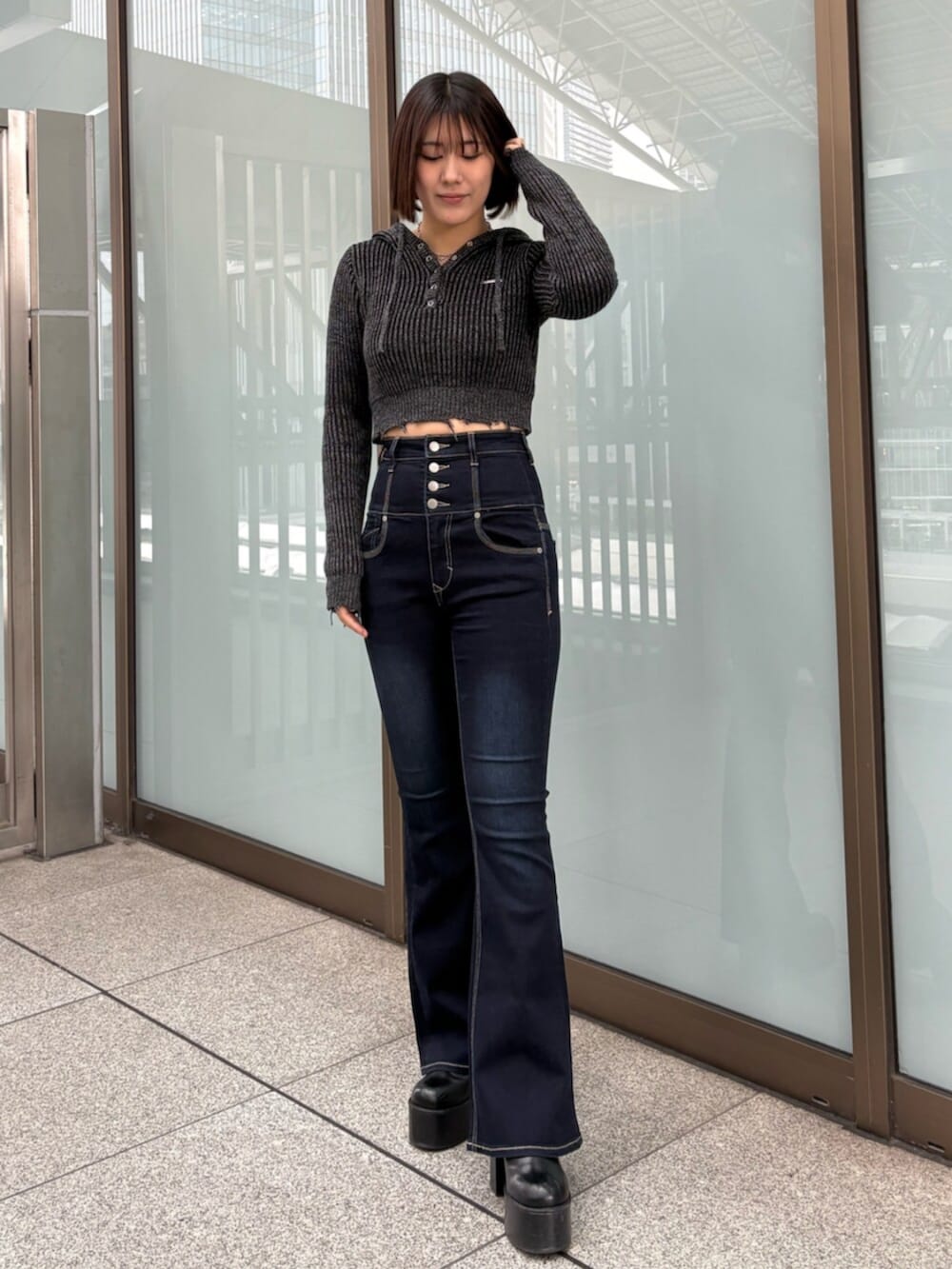 ブラウン系のブルゾン、ブラック系のデニムパンツ、ブラック系のニット/セーターを着用したレディースの冬コーディネートの6枚目の写真