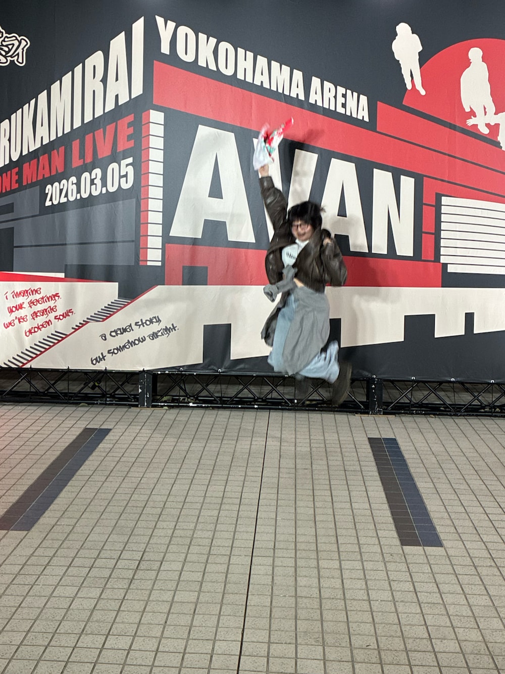 ブラック系のスウェット、ブラウン系のブーツ、ブルー系のデニムパンツを着用したレディースの春コーディネートの2枚目の写真