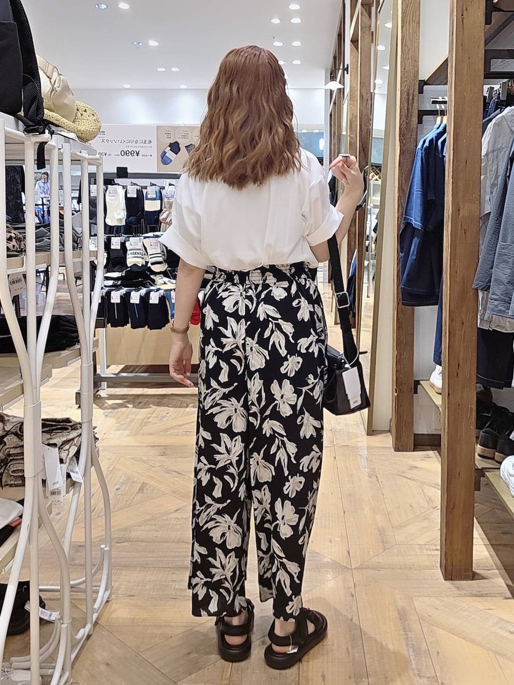 ブラック系のショルダーバッグ、ホワイト系のTシャツ/カットソー、ブラック系のその他パンツを着用したレディースの春コーディネートの2枚目の写真