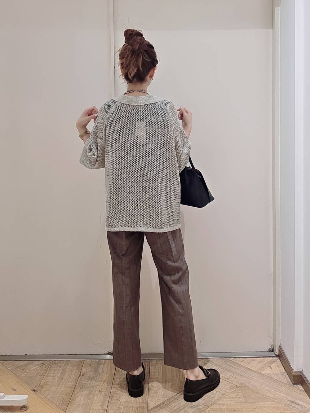 ブラック系のショルダーバッグ、ブルー系のその他パンツ、グレー系のニット/セーターを着用したレディースの秋コーディネートの2枚目の写真