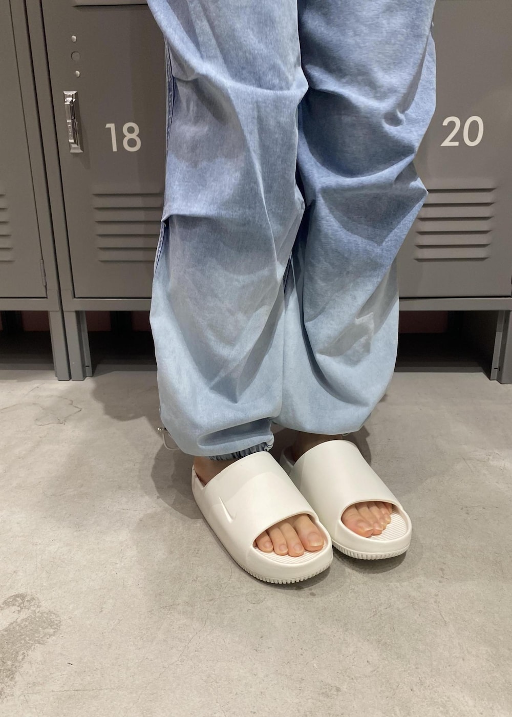 ブルー系のその他パンツ、ホワイト系のサンダル、グリーン系のTシャツ/カットソーを着用したレディースの春コーディネートの6枚目の写真