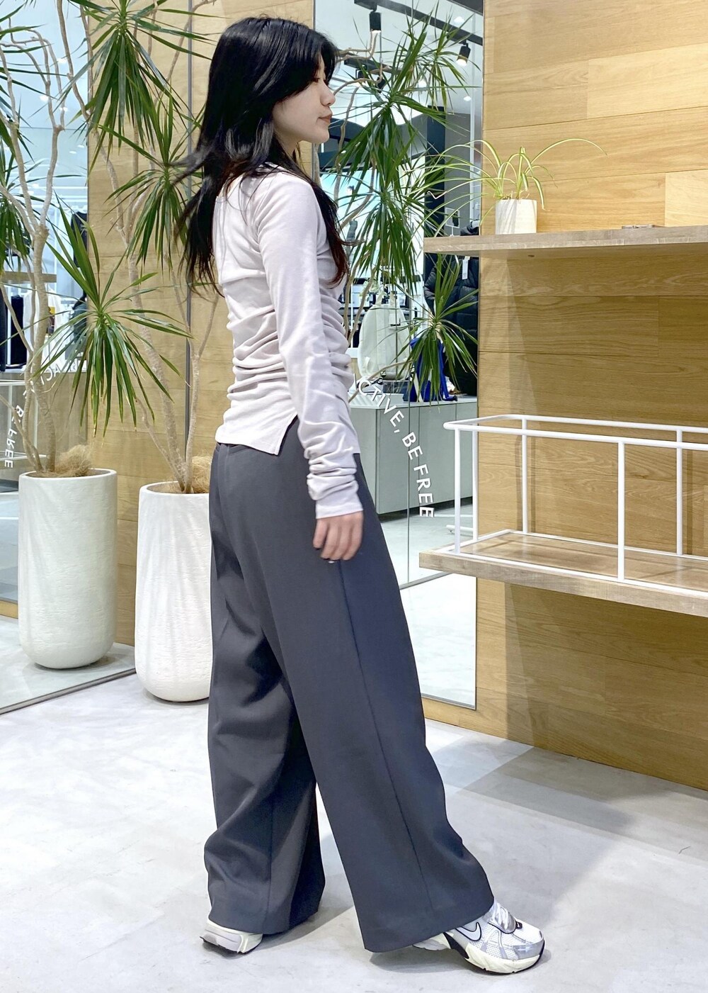 ホワイト系のスニーカー、グレー系のスラックス、パープル系のTシャツ/カットソーを着用したレディースの秋コーディネートの6枚目の写真