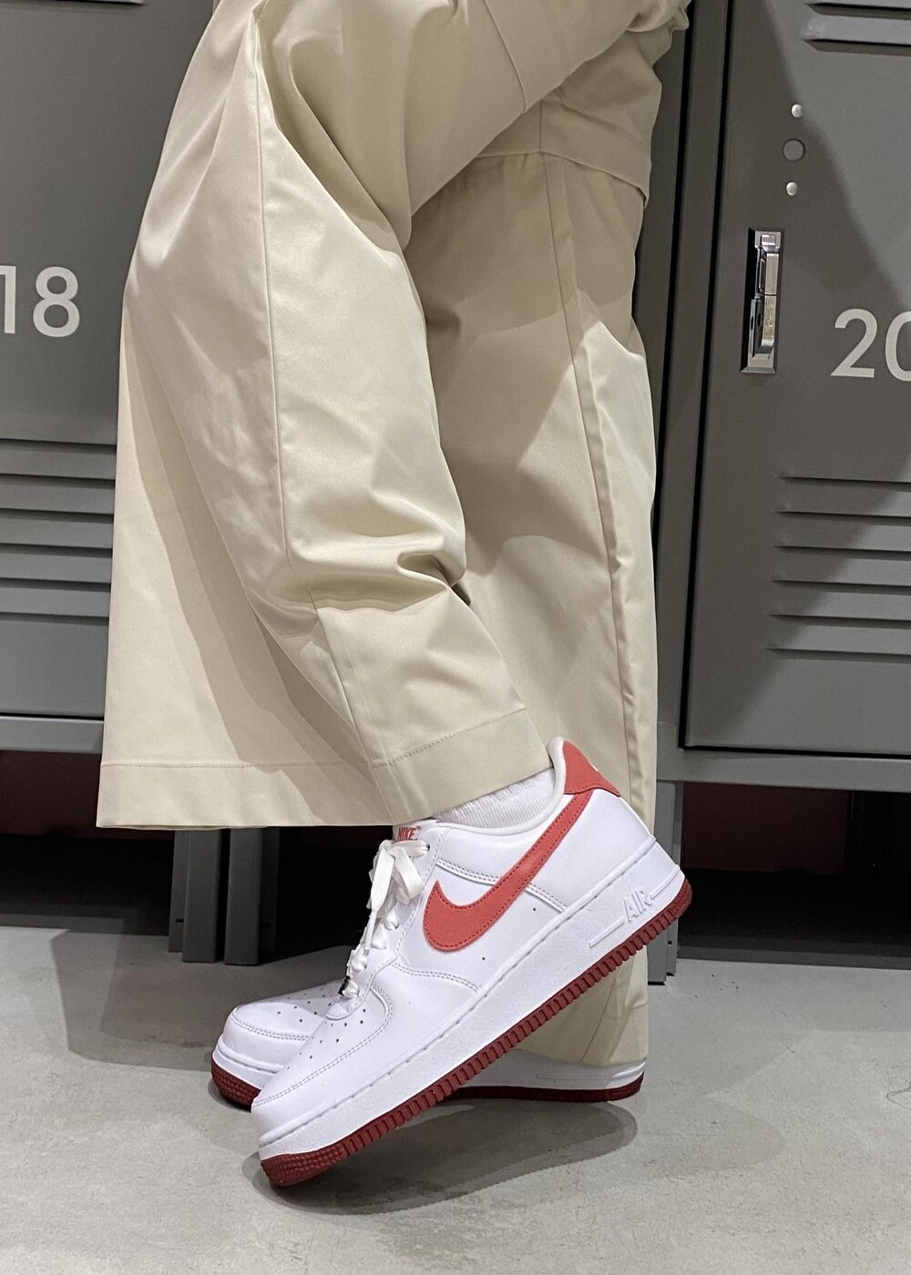 ホワイト系のスニーカー、レッド系のタンクトップ、グレー系のその他パンツを着用したレディースの冬コーディネートの6枚目の写真