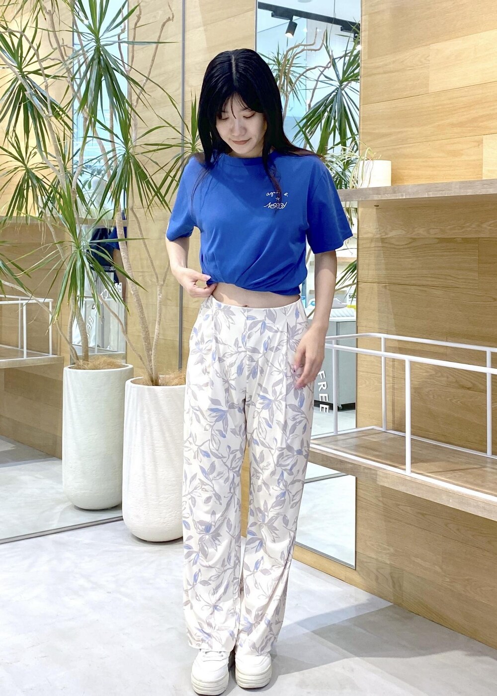 ベージュ系のその他パンツ、ホワイト系のスニーカー、ブルー系のTシャツ/カットソーを着用したレディースの夏コーディネートの8枚目の写真