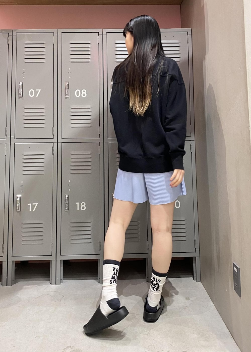 ブラック系のスウェット、ブルー系のその他パンツ、ブラック系のサンダルを着用したレディースの春コーディネートの3枚目の写真