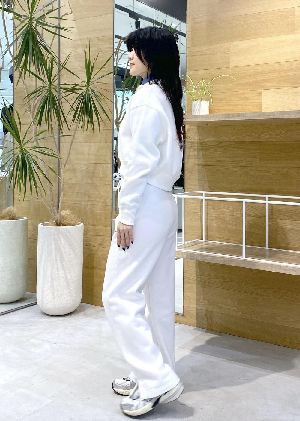 ホワイト系のスニーカー、ブルー系のニット/セーター、ブラック系のその他パンツを着用したレディースの秋コーディネートの3枚目の写真