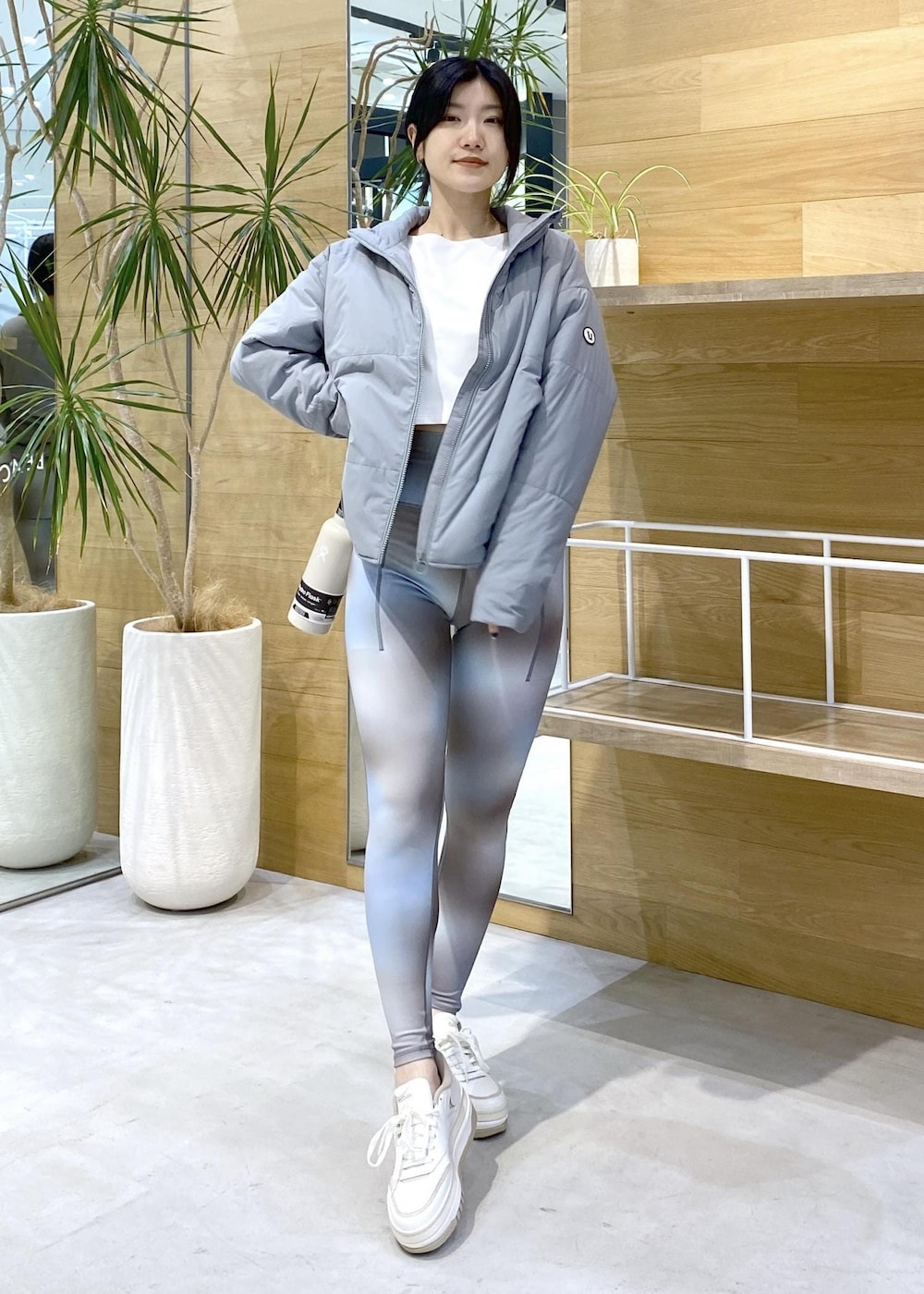 グリーン系のダウンジャケット/コート、ブルー系のレギンス/スパッツを着用したレディースの秋コーディネートの5枚目の写真