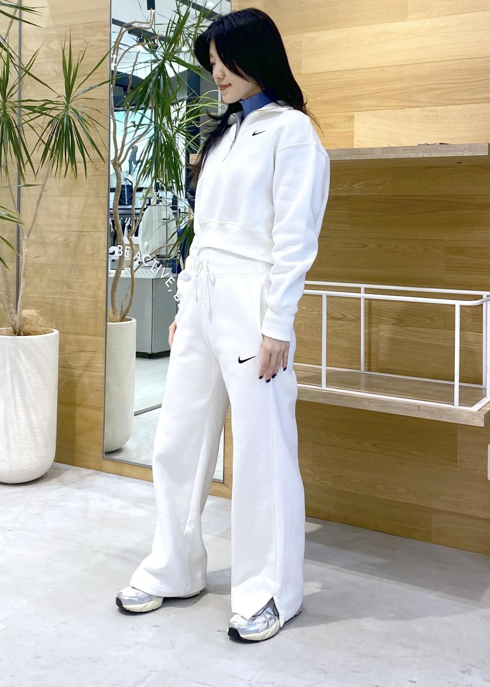 ホワイト系のスニーカー、ブルー系のニット/セーター、ブラック系のその他パンツを着用したレディースの秋コーディネートの2枚目の写真