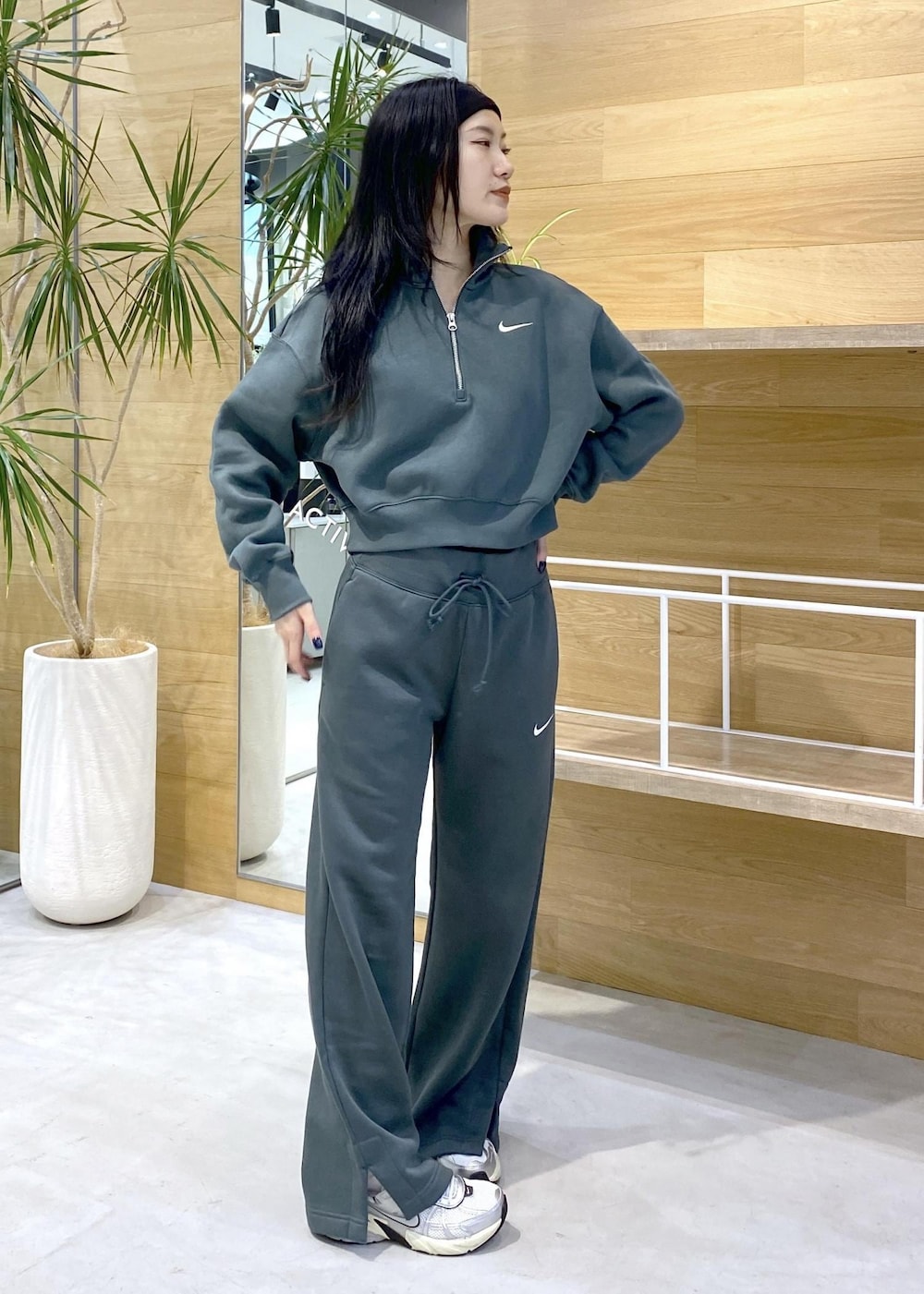 ホワイト系のスニーカー、グリーン系のスウェットを着用したレディースの秋コーディネートの6枚目の写真