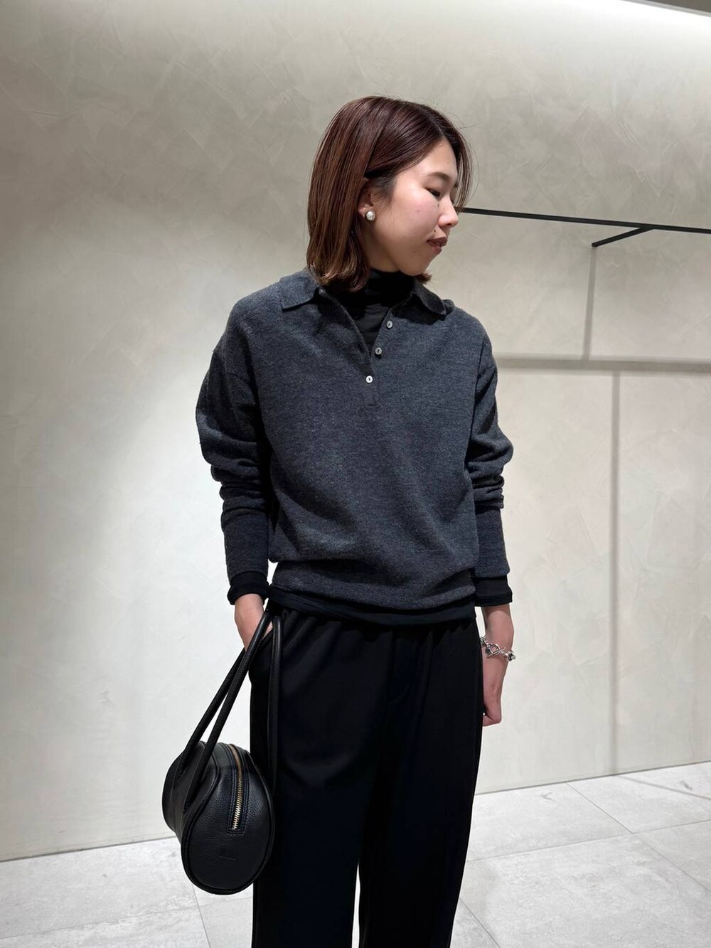 ブラック系のスニーカー、ブラック系のTシャツ/カットソー、グレー系のニット/セーターを着用したレディースの冬コーディネートの7枚目の写真