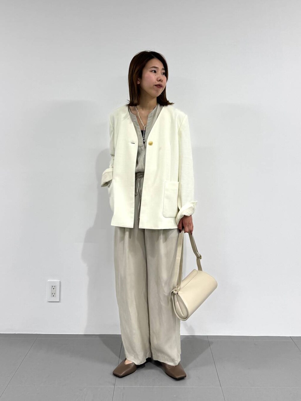 ホワイト系のショルダーバッグ、ブラック系のキャミソール、ベージュ系のつなぎ/オールインワンを着用したレディースの春コーディネートの8枚目の写真