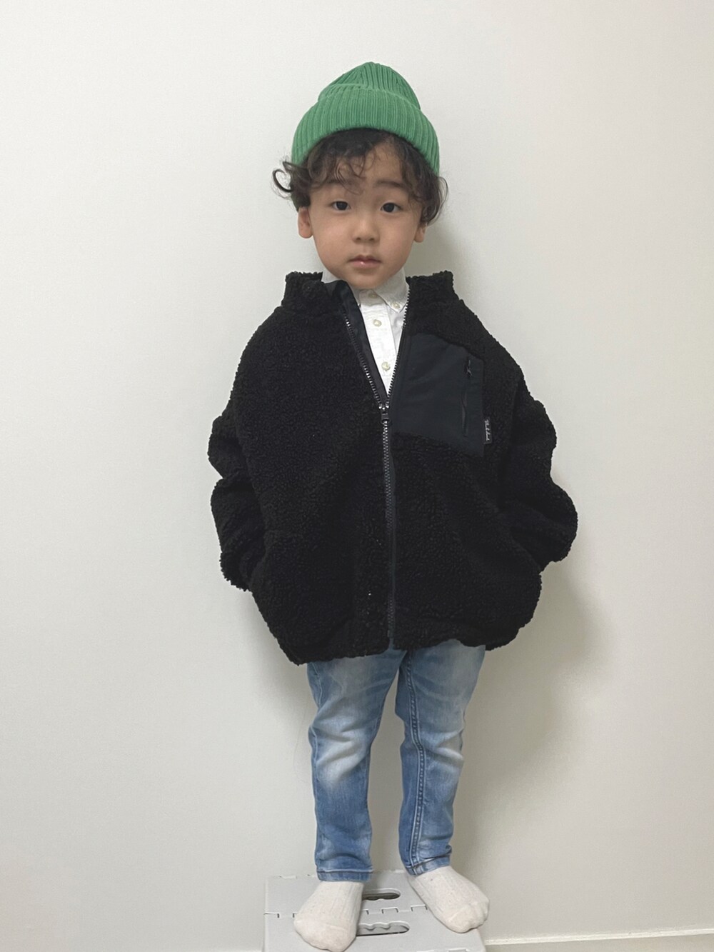 ブラック系のその他アウター、ブルー系のデニムパンツ、ホワイト系のシャツ/ブラウスを着用したキッズの冬コーディネートの3枚目の写真