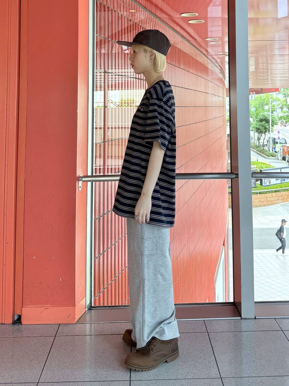 ブルー系のTシャツ/カットソー、グレー系のカーゴパンツ、ブラウン系のキャップを着用したレディースの春コーディネートの2枚目の写真