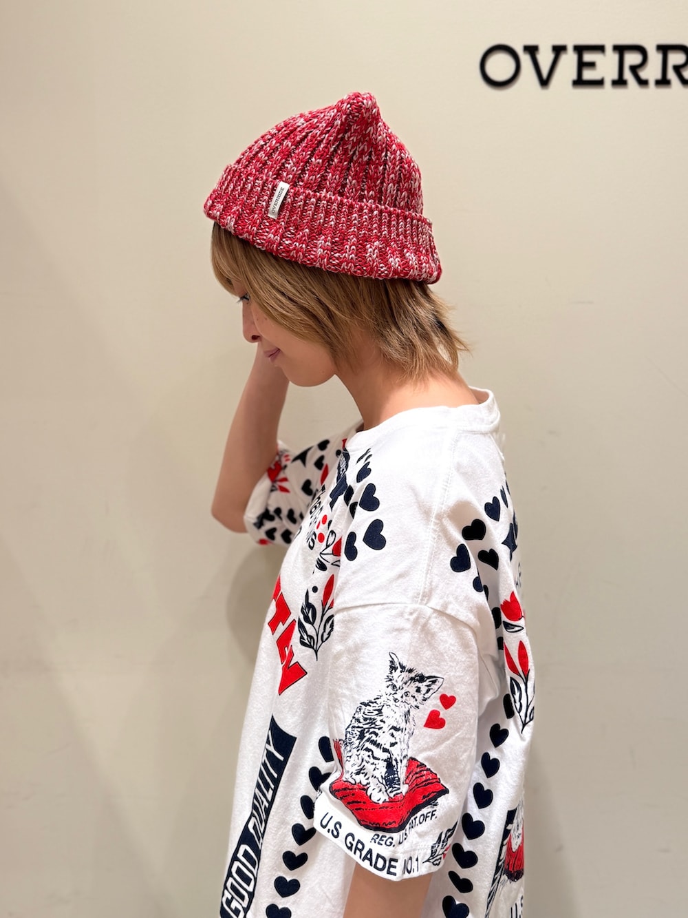 レッド系のニットキャップ/ビーニーを着用したレディースの夏コーディネートの2枚目の写真