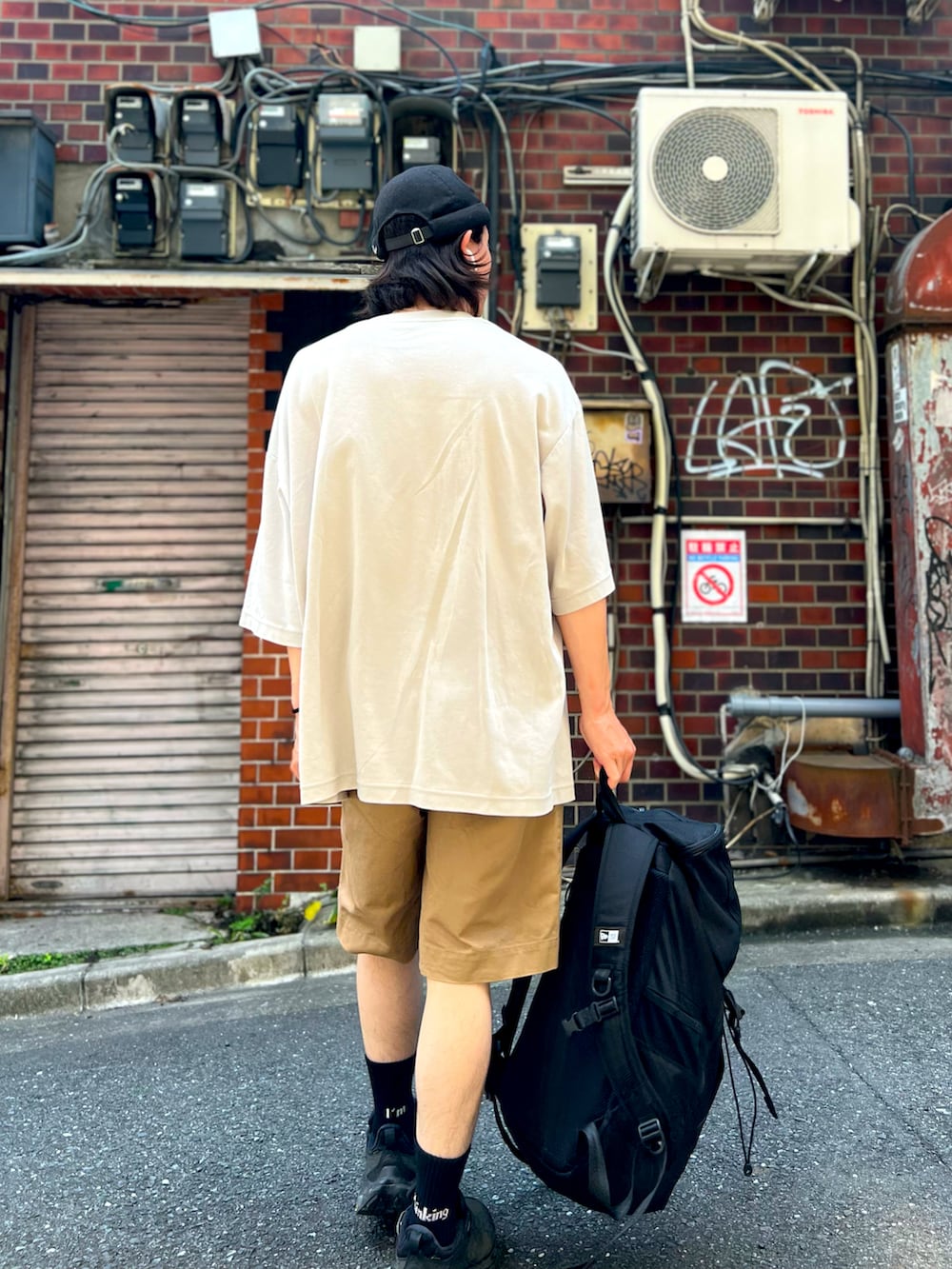 ブラウン系のパンツ、グレー系のTシャツ/カットソー、ブラック系のバックパック/リュックを着用したメンズの夏コーディネートの2枚目の写真