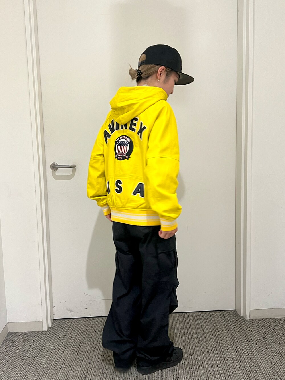 ベージュ系のその他アウター、ブラック系のカーゴパンツ、ブラック系の帽子を着用したレディースの秋コーディネートの2枚目の写真