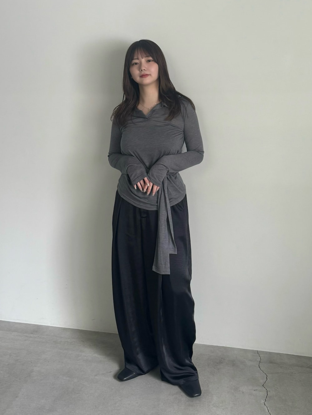 グレー系のTシャツ/カットソー、ブラック系のスラックス、ブラック系のスリッポンを着用したレディースの春コーディネートの9枚目の写真