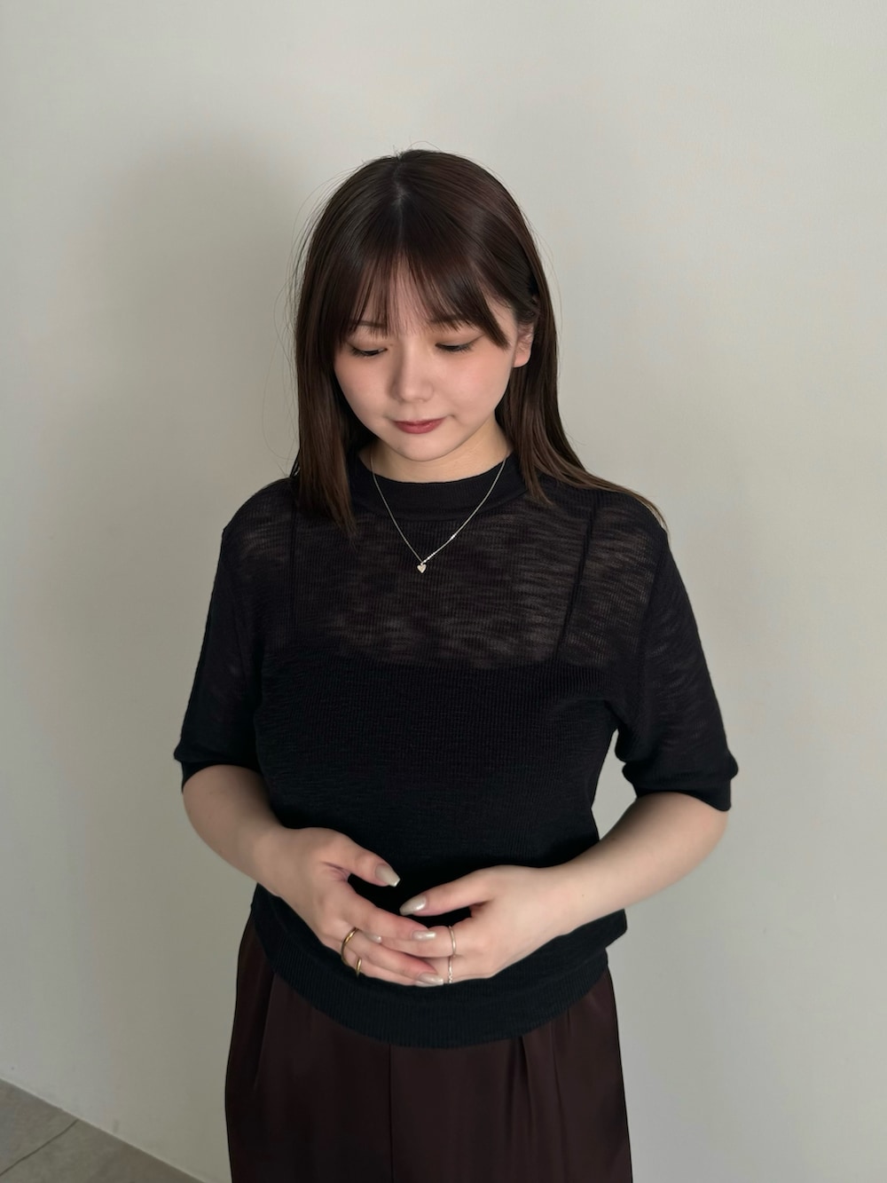 ブラック系のニット/セーター、ブラック系のキャミソール、ブラウン系のその他パンツを着用したレディースの春コーディネートの4枚目の写真