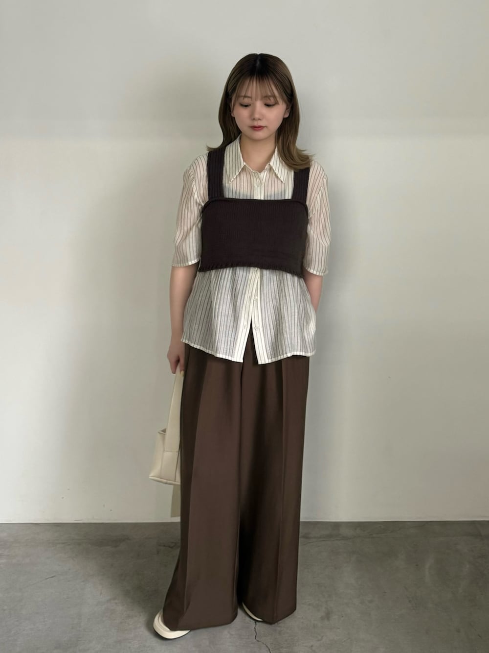 ホワイト系のシャツ/ブラウス、ブラウン系のベスト、ブラック系のキャミソールを着用したレディースの夏コーディネートの2枚目の写真