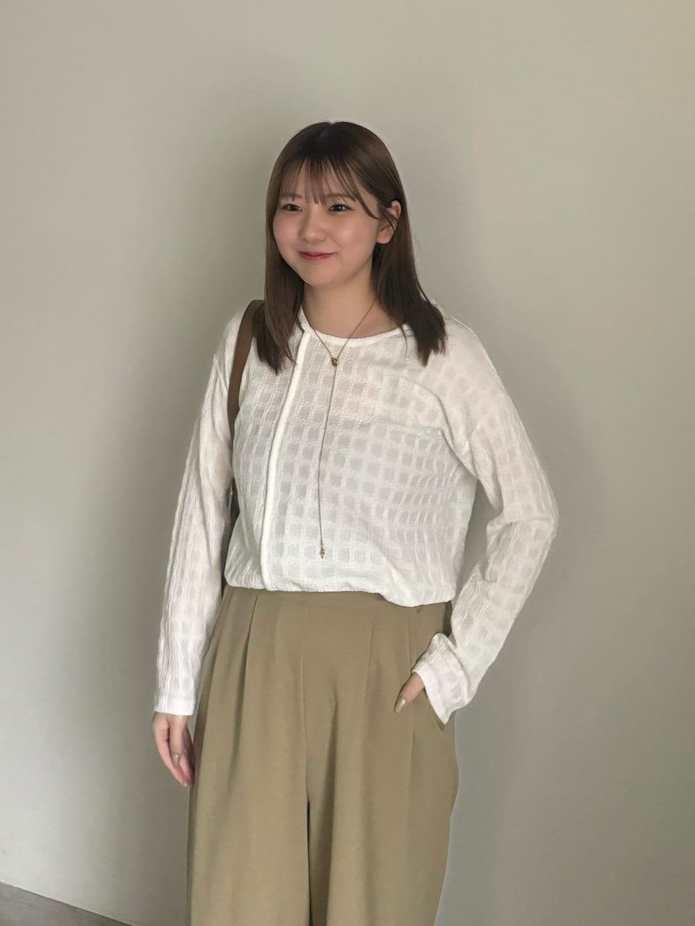 ホワイト系のTシャツ/カットソー、ブラック系のキャミソール、ベージュ系のパンプスを着用したレディースの夏コーディネートの4枚目の写真
