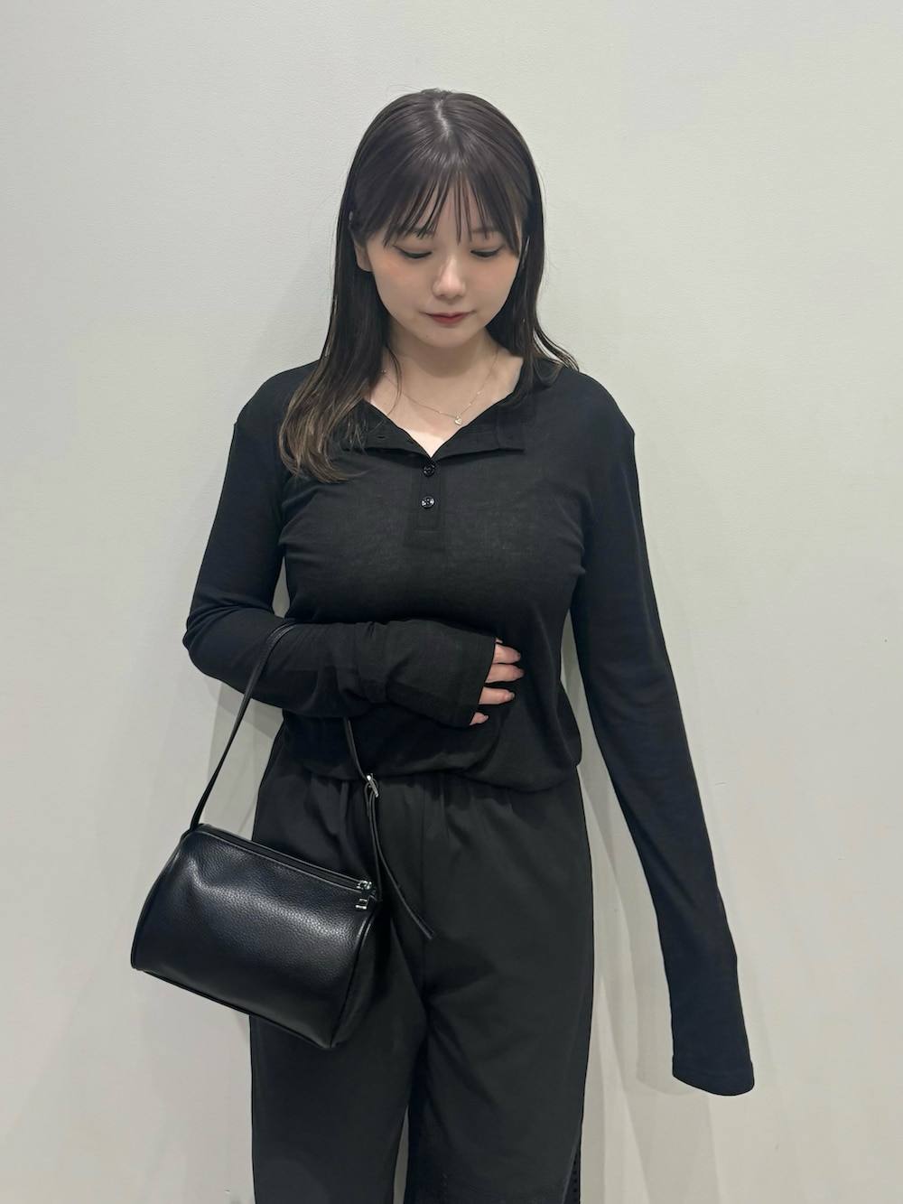 ブラック系のTシャツ/カットソー、ブラック系のハンドバッグ、ブラック系のその他パンツを着用したレディースの春コーディネートの6枚目の写真