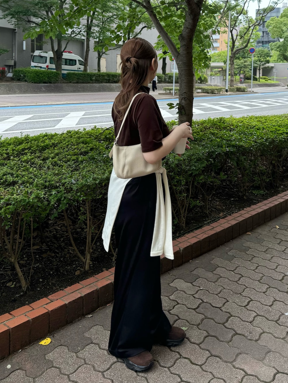 ブラウン系のTシャツ/カットソー、ホワイト系のハンドバッグ、ベージュ系のTシャツ/カットソーを着用したレディースの夏コーディネートの3枚目の写真
