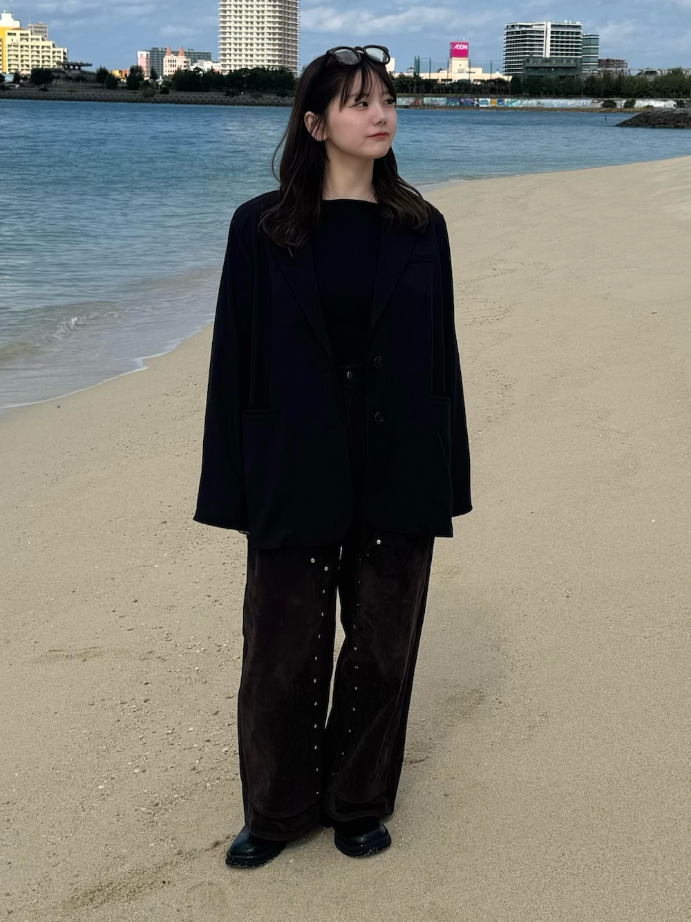 ブラック系のテーラードジャケット、ブラック系のTシャツ/カットソー、ブラック系のスリッポンを着用したレディースの冬コーディネートの2枚目の写真