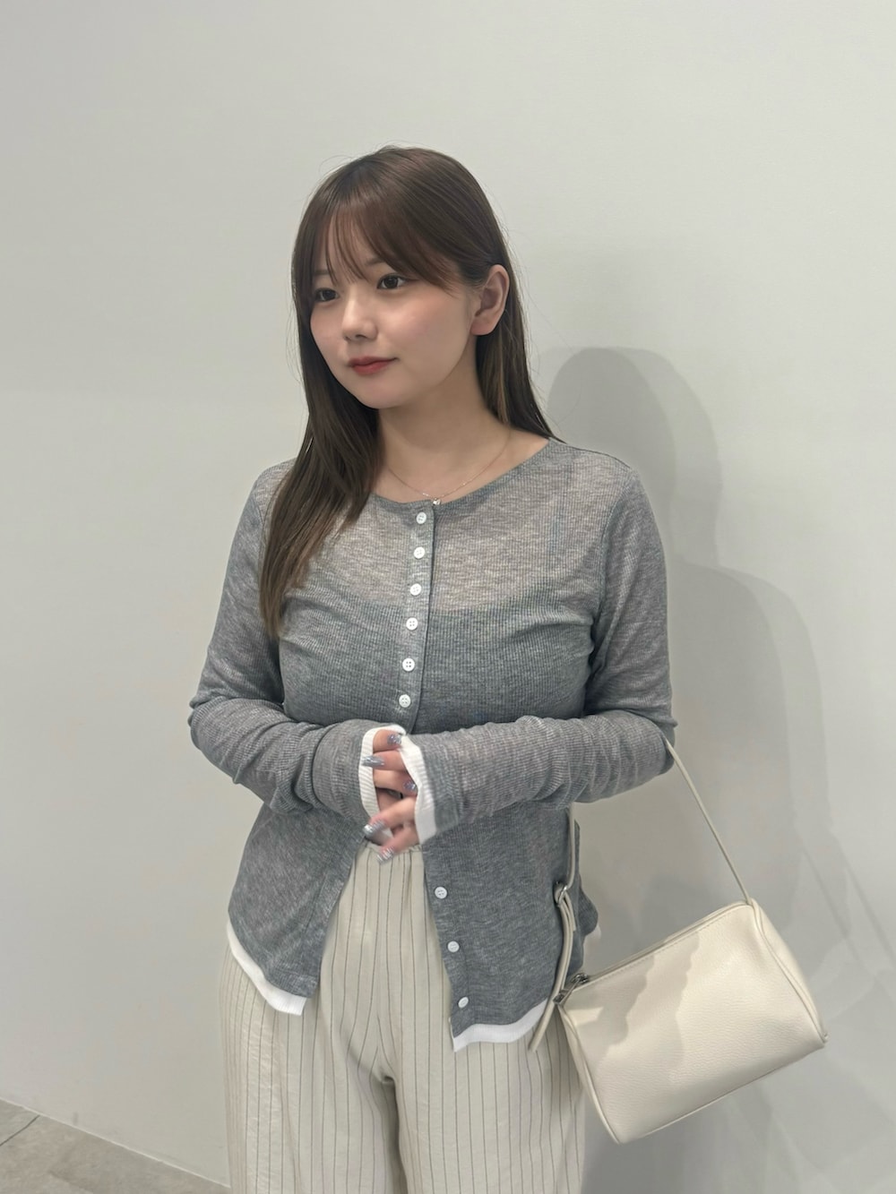 グレー系のカーディガン/ボレロ、ブラック系のキャミソール、ホワイト系のその他パンツを着用したレディースの夏コーディネートの3枚目の写真