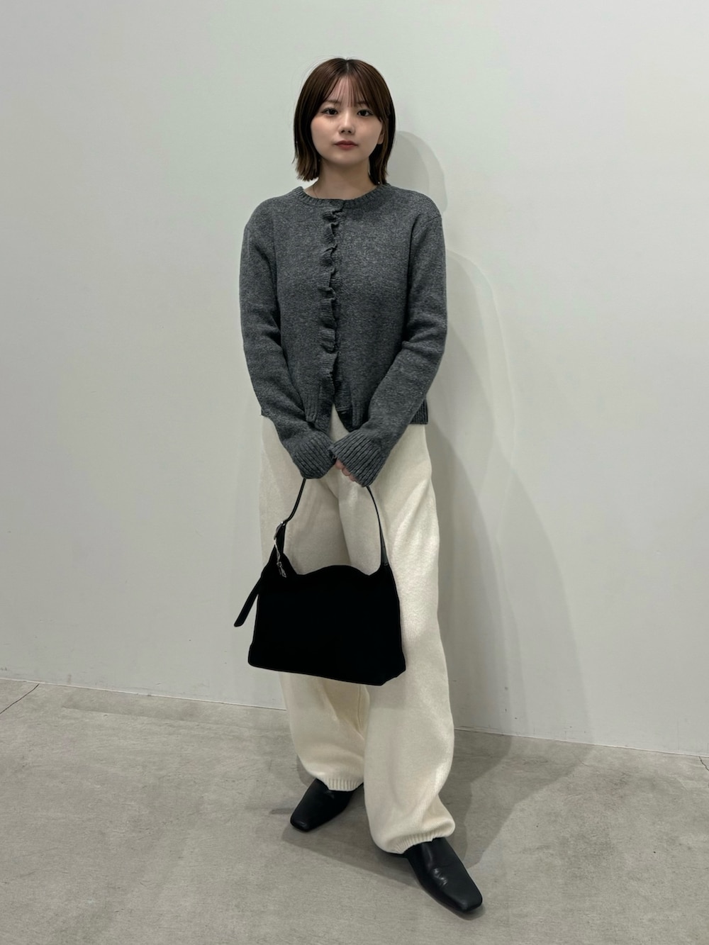 グレー系のカーディガン/ボレロ、ホワイト系のその他パンツ、ブラック系のスリッポンを着用したレディースの秋コーディネートの3枚目の写真