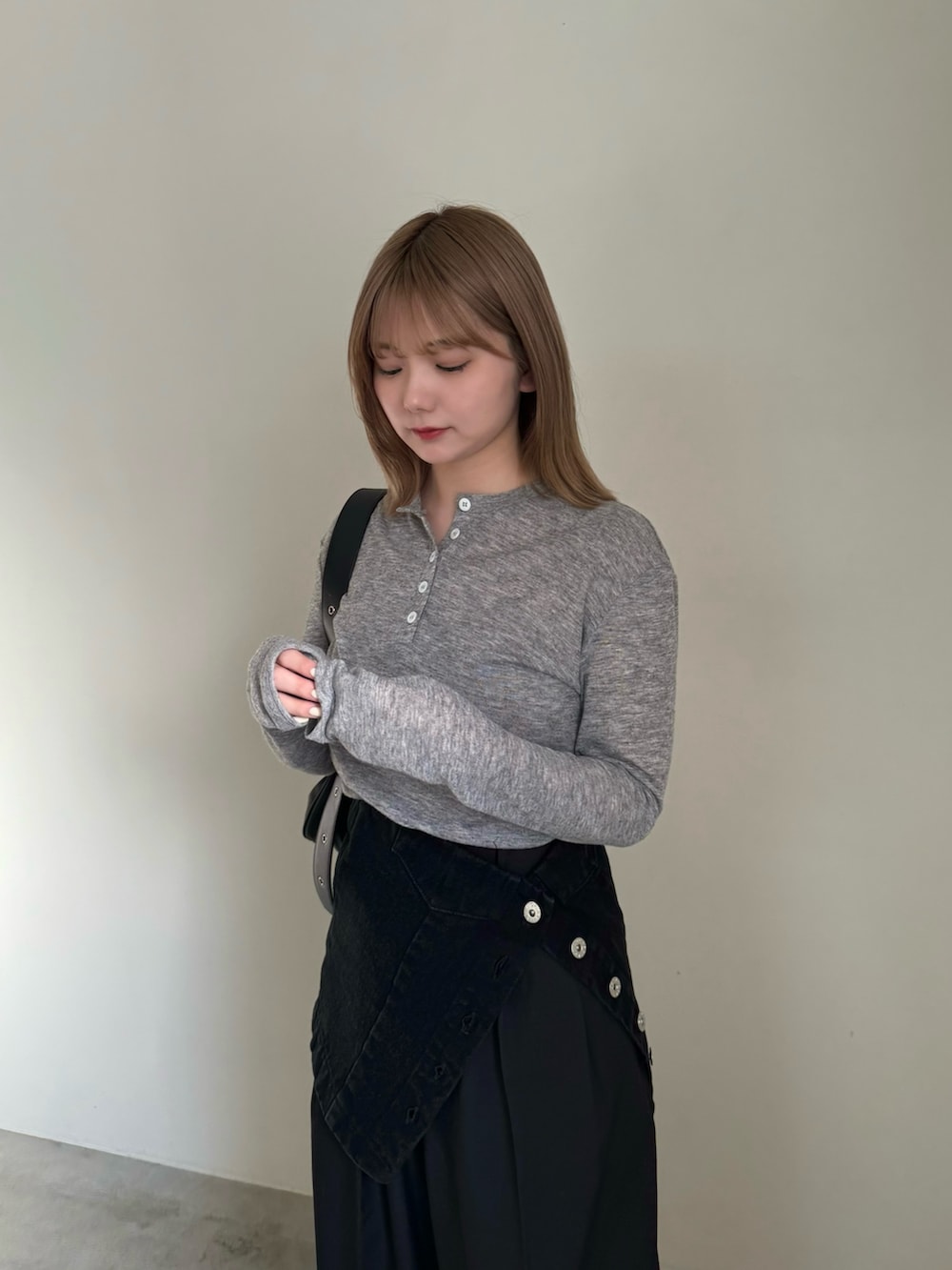 ブラック系のチューブトップ、ブラック系のスラックス、ブラック系のショルダーバッグを着用したレディースの春コーディネートの4枚目の写真