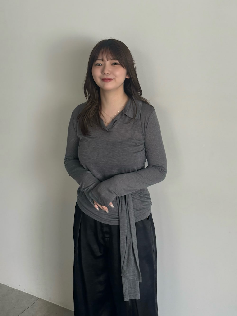 グレー系のTシャツ/カットソー、ブラック系のスラックス、ブラック系のスリッポンを着用したレディースの春コーディネートの6枚目の写真