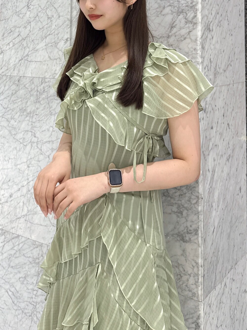 グリーン系のワンピース、ブラウン系のローファーを着用したレディースの春コーディネートの4枚目の写真