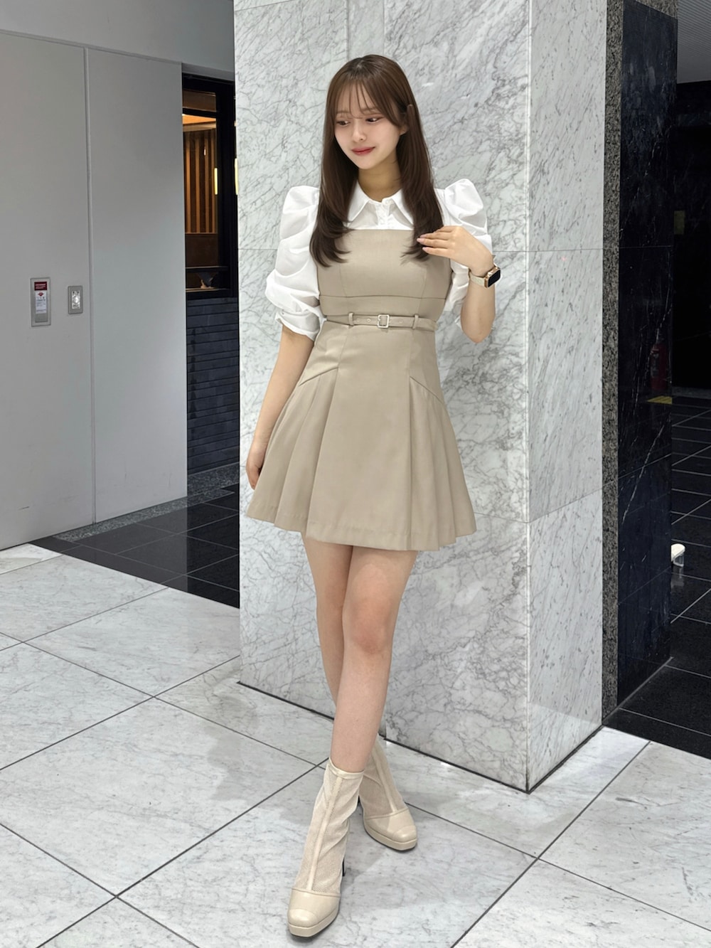 ベージュ系のワンピース、ベージュ系のブーツを着用したレディースの春コーディネートの2枚目の写真