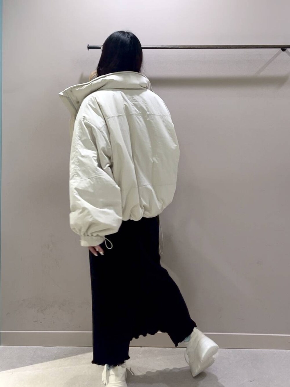 レッド系のニット/セーター、ホワイト系のその他アウター、ブラック系のスカートを着用したレディースの冬コーディネートの5枚目の写真