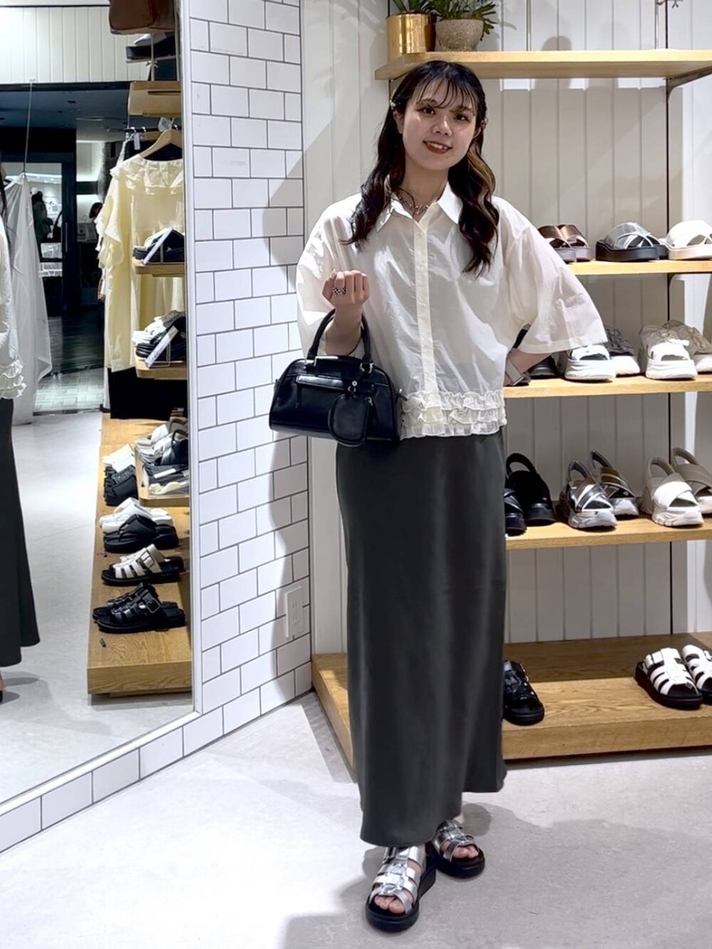 ベージュ系のTシャツ/カットソー、グレー系のスカート、シルバー系のサンダルを着用したレディースの夏コーディネートの7枚目の写真