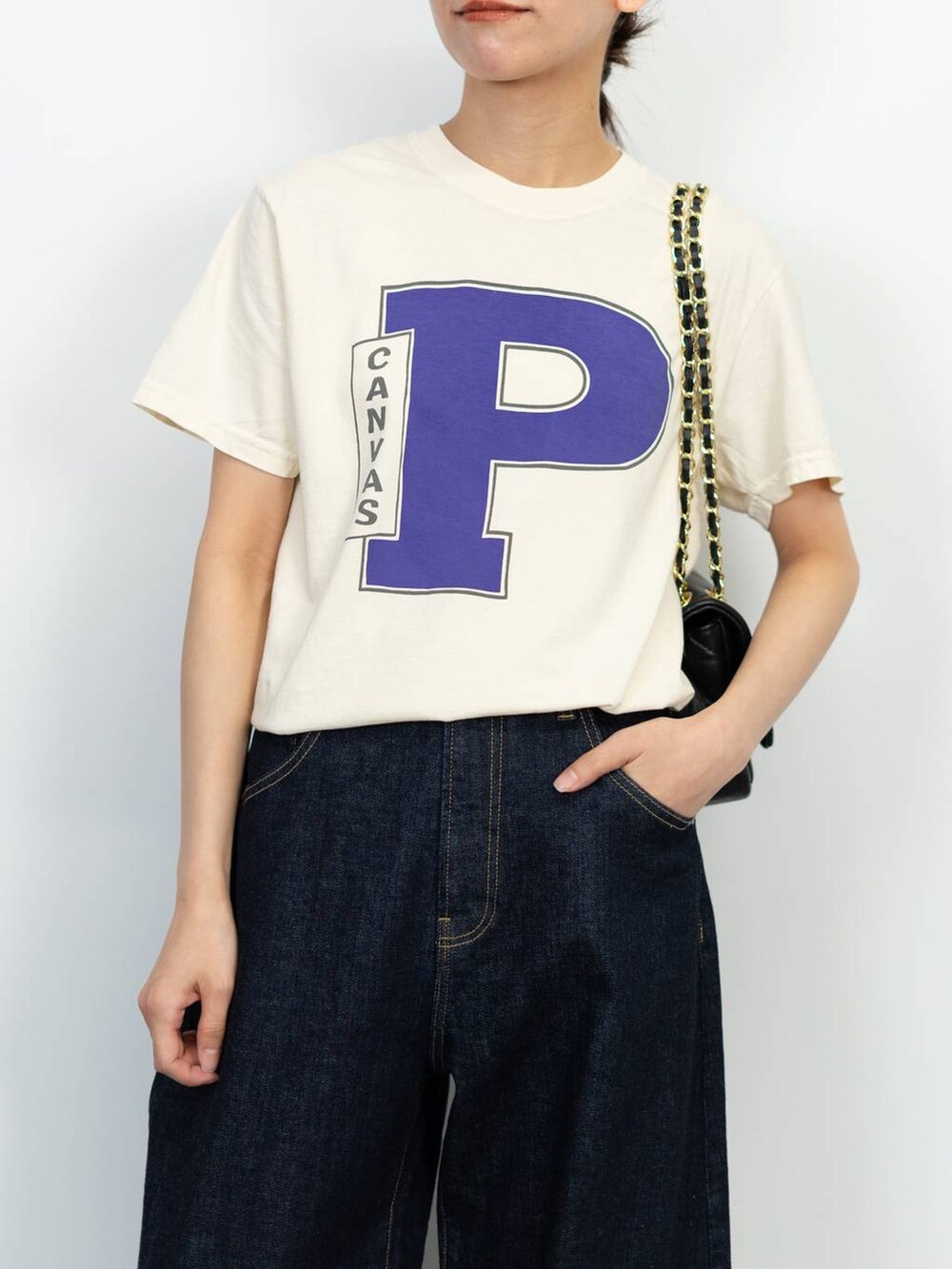 ブラック系のローファー、ブラック系のショルダーバッグ、ブルー系のデニムパンツを着用したレディースの春コーディネートの3枚目の写真