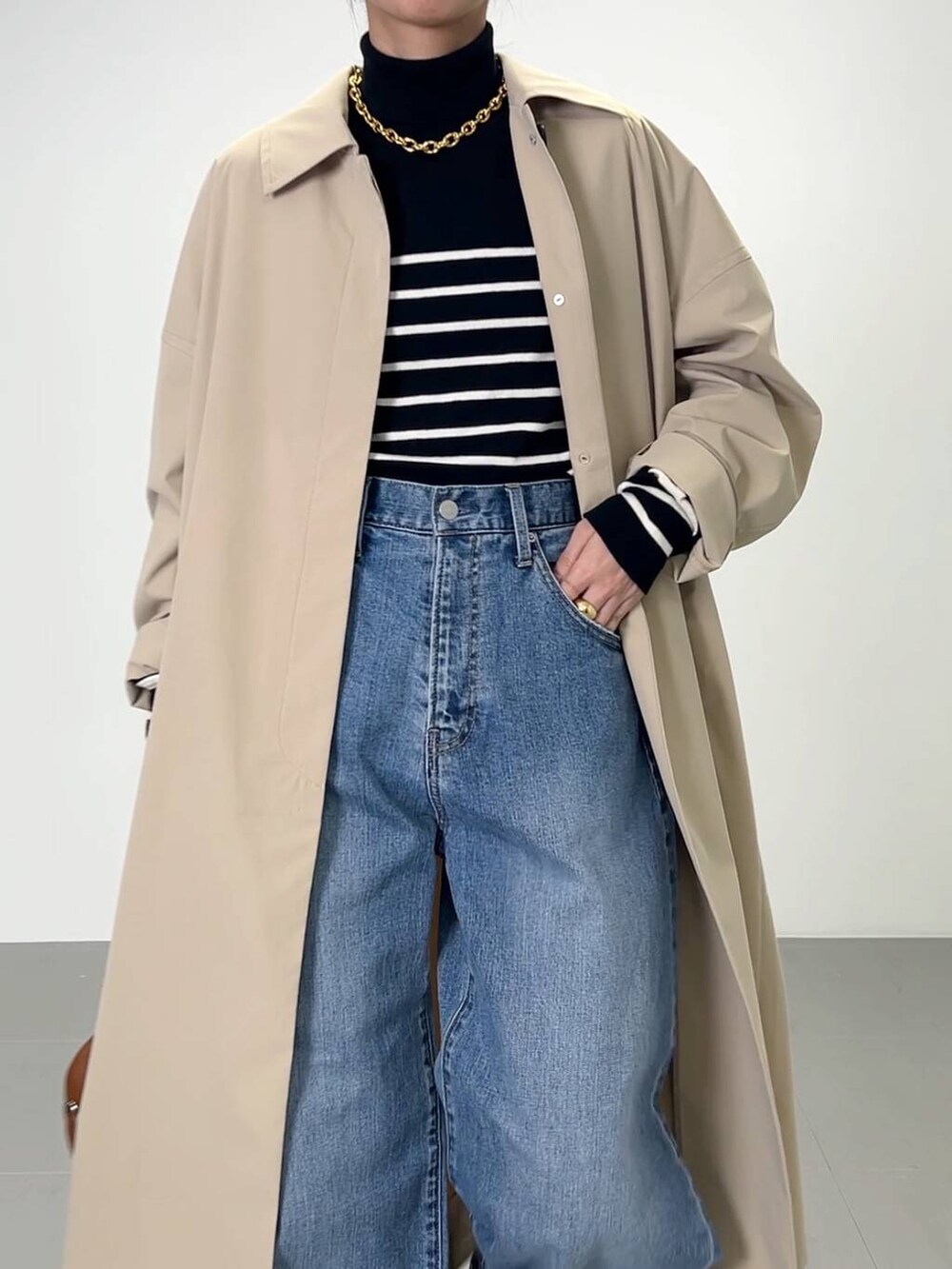 ブラック系のローファー、ブラック系のニット/セーター、ブラウン系のハンドバッグを着用したレディースの冬コーディネートの5枚目の写真