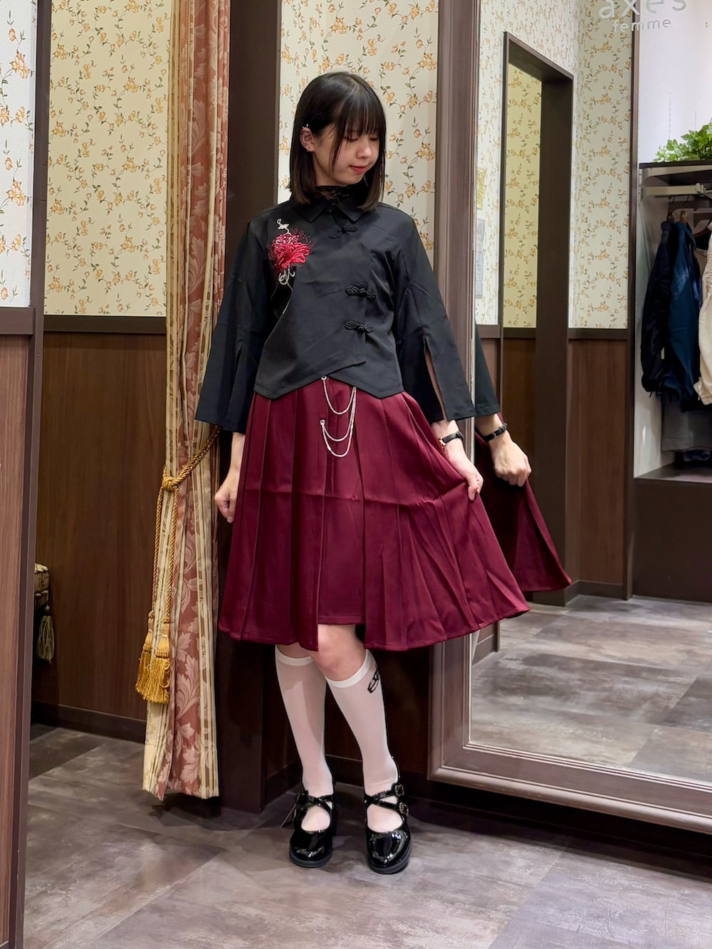 ブラック系のシャツ/ブラウス、ブラック系のTシャツ/カットソー、レッド系のスカートを着用したレディースの夏コーディネートの4枚目の写真