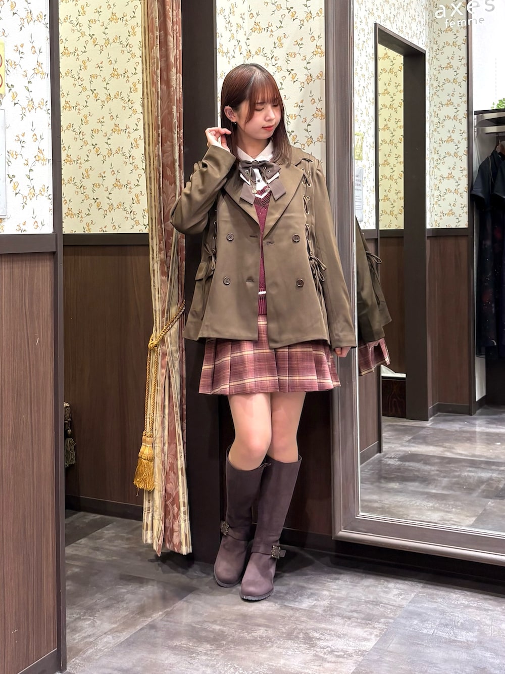 レッド系のベスト、ピンク系のその他パンツ、ブラウン系のブーツを着用したレディースの秋コーディネートの3枚目の写真