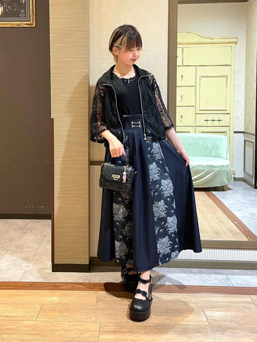 ブラック系のタンクトップ、ブルー系のスカート、その他のパンプスを着用したレディースの夏コーディネートの2枚目の写真