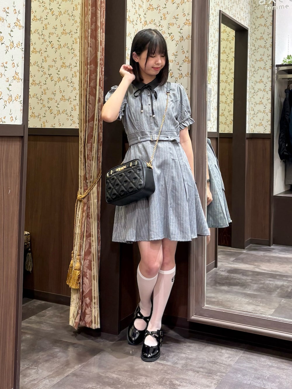 ホワイト系のタンクトップ、グレー系のワンピース、ブラック系のショルダーバッグを着用したレディースの夏コーディネートの2枚目の写真