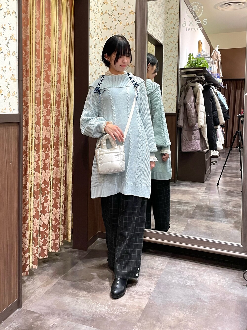 ベージュ系のダウンジャケット/コート、グリーン系のチュニック、ブラック系のその他パンツを着用したレディースの冬コーディネートの4枚目の写真