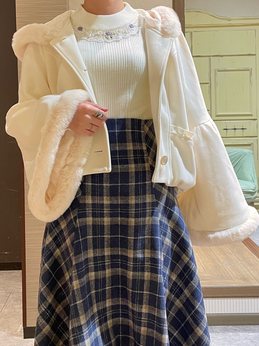 ホワイト系のその他アウター、ホワイト系のニット/セーター、ブルー系のスカートを着用したレディースの秋コーディネートの3枚目の写真