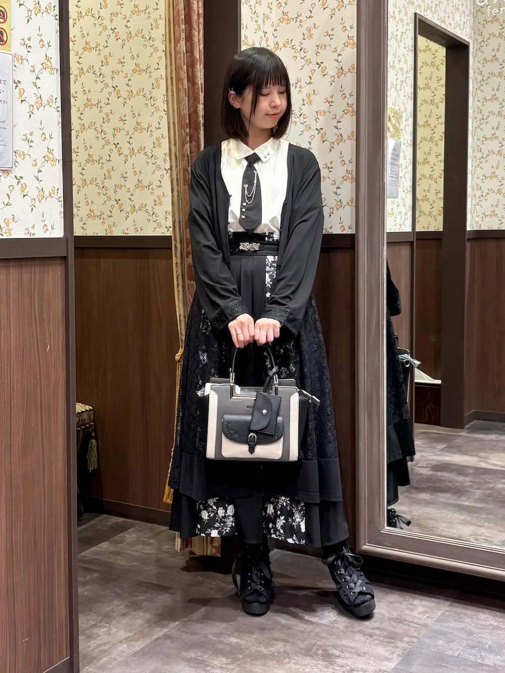 ホワイト系のシャツ/ブラウス、ブラック系のカーディガン/ボレロ、ブラック系のスカートを着用したレディースの夏コーディネートの4枚目の写真