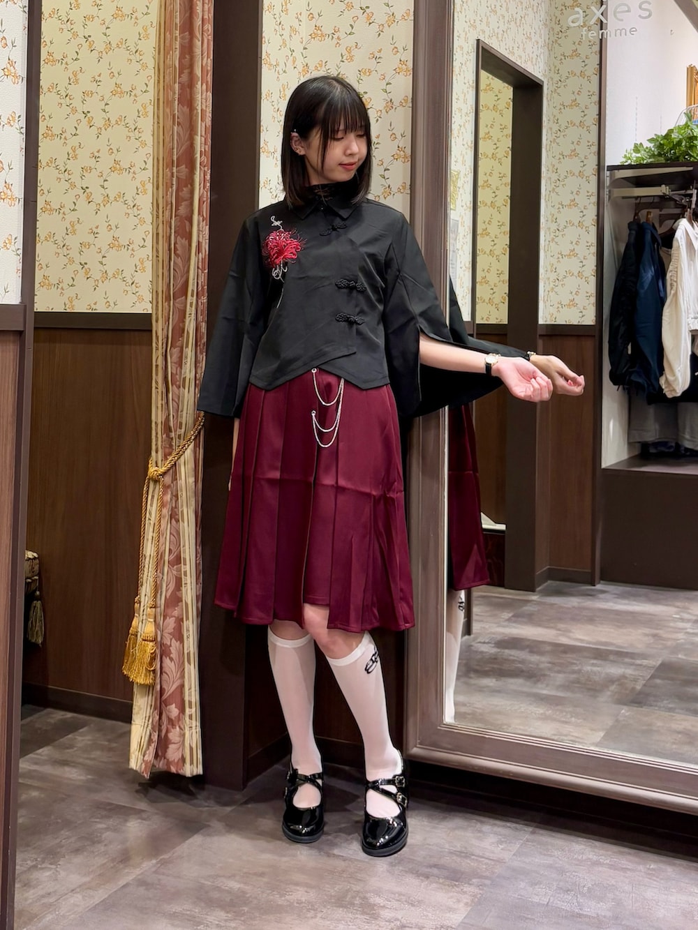 ブラック系のシャツ/ブラウス、ブラック系のTシャツ/カットソー、レッド系のスカートを着用したレディースの夏コーディネートの2枚目の写真