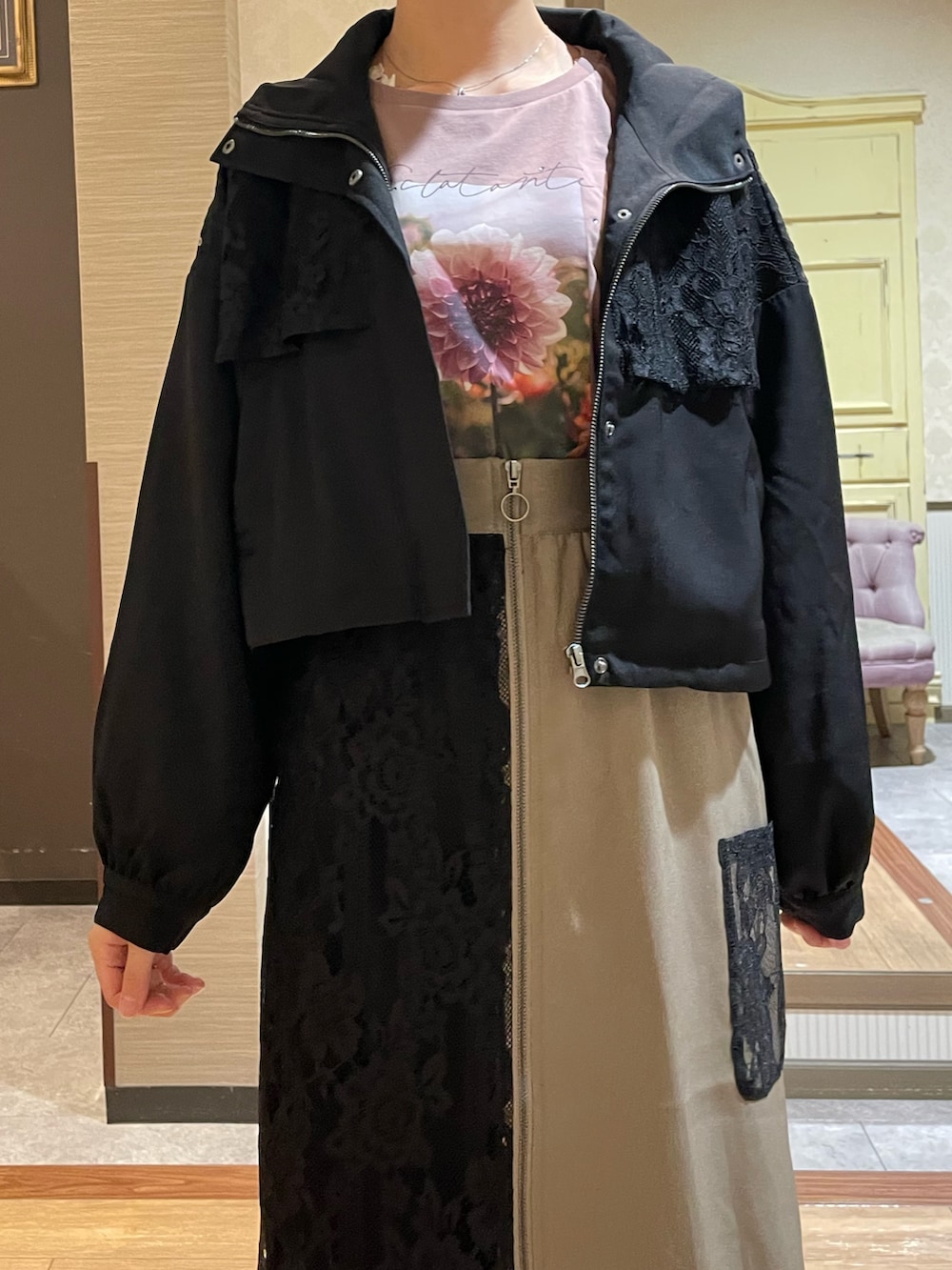 ベージュ系のスカート、ブラウン系のTシャツ/カットソー、ブラック系のブルゾンを着用したレディースの秋コーディネートの5枚目の写真