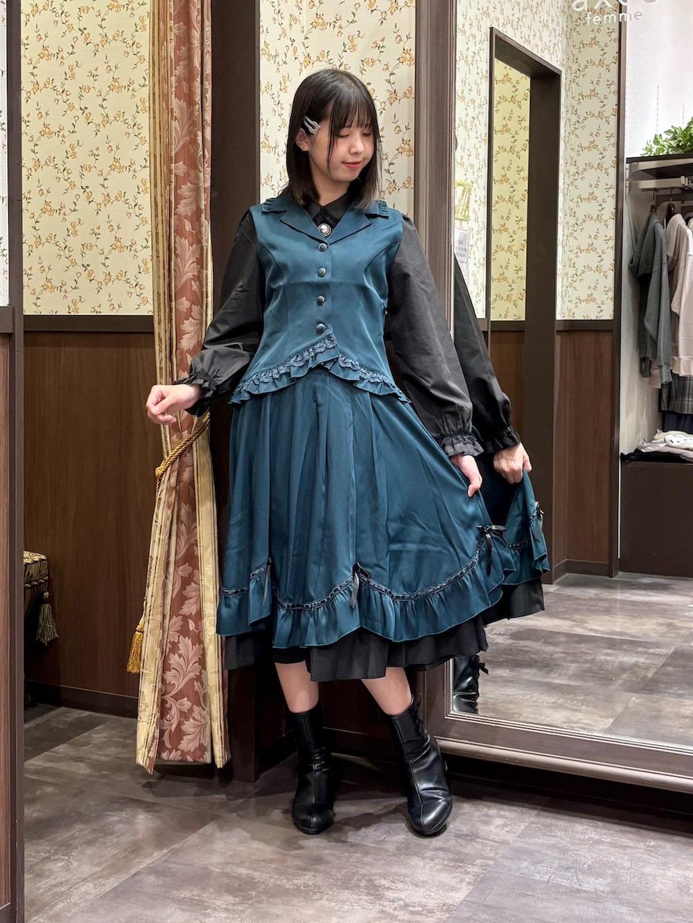 ブラック系のシャツ/ブラウス、ブルー系のベスト、ブルー系のスカートを着用したレディースの夏コーディネートの2枚目の写真