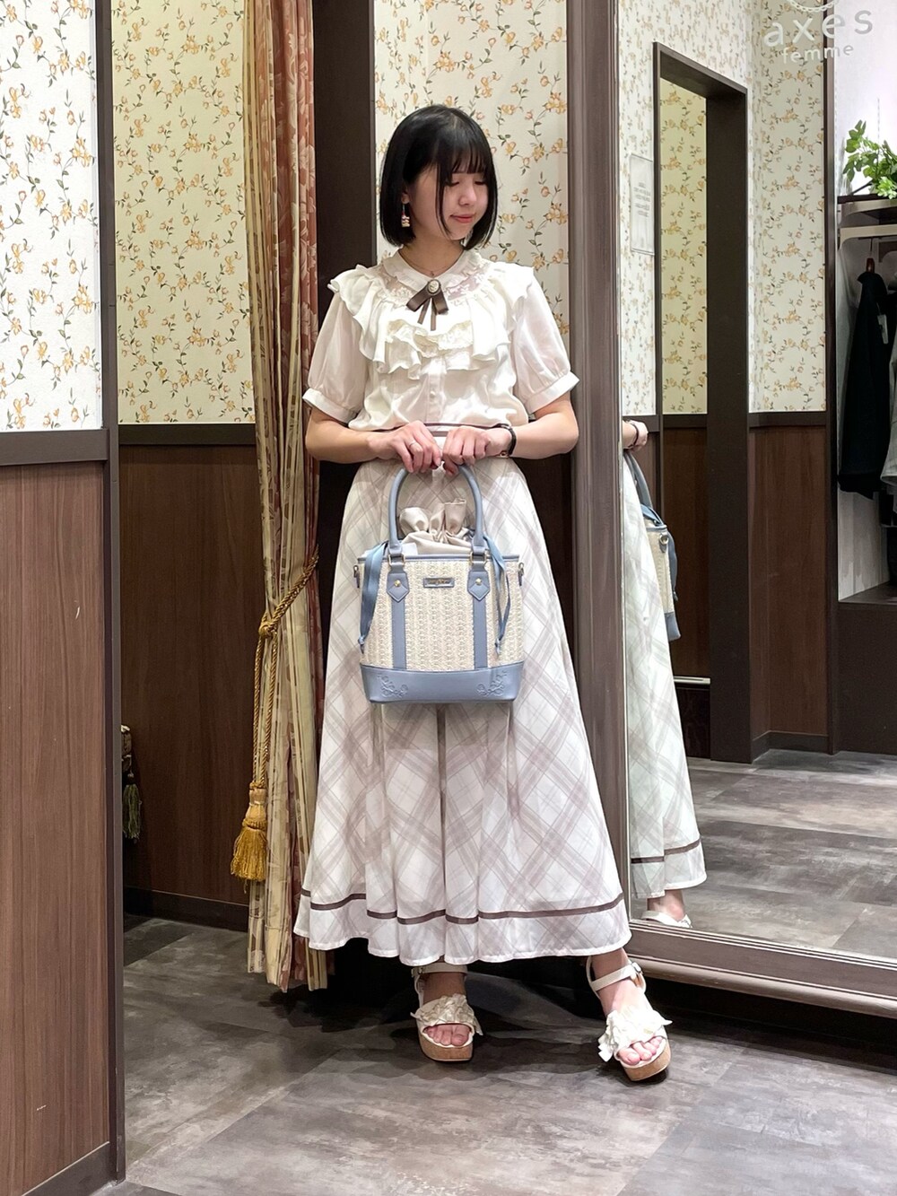 ホワイト系のシャツ/ブラウス、ホワイト系のカーディガン/ボレロ、ホワイト系のスカートを着用したレディースの春コーディネートの2枚目の写真